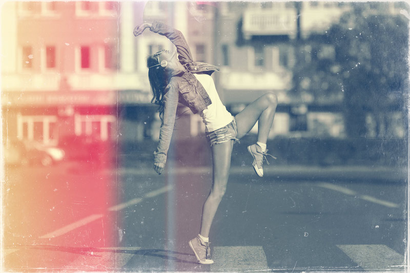 Beautiful dancing girl on street with vintage Photoshop action
