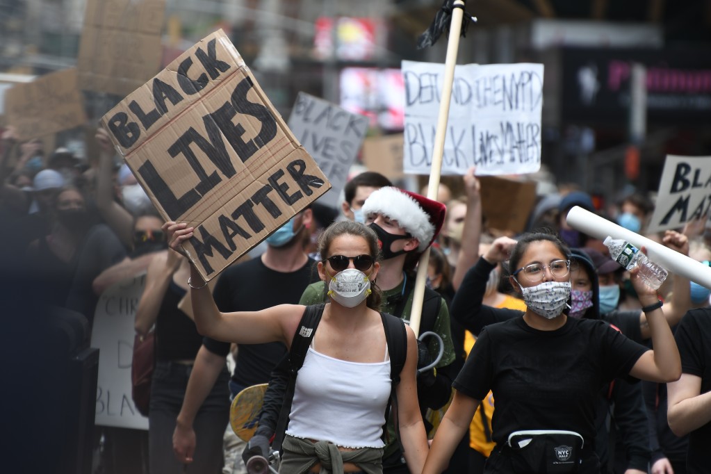 black lives matter protest on the street with signs