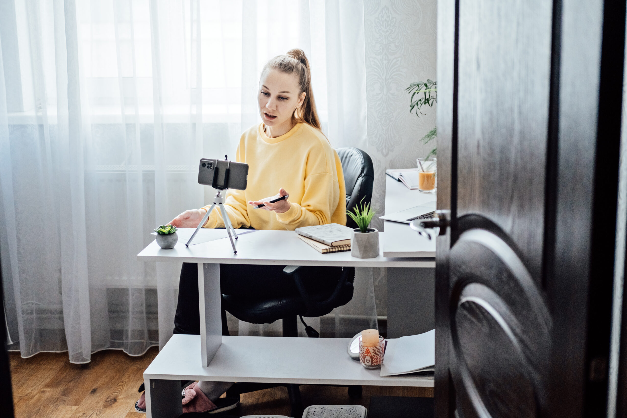 Passive Income, Side Hustle Ideas to Earn at Home. Young woman speaking in front of camera for vlog as blogger, recording video tutorial or training course. Earn extra money, money making.
