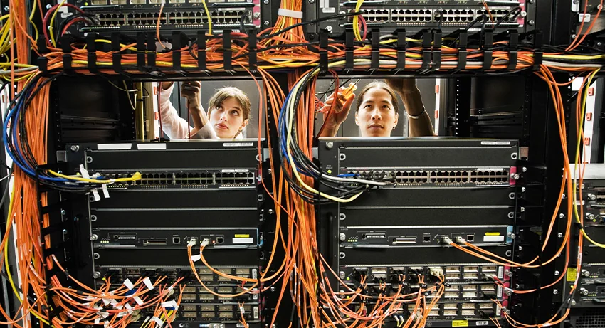 technicians working on a CAT 5 cable bundling system