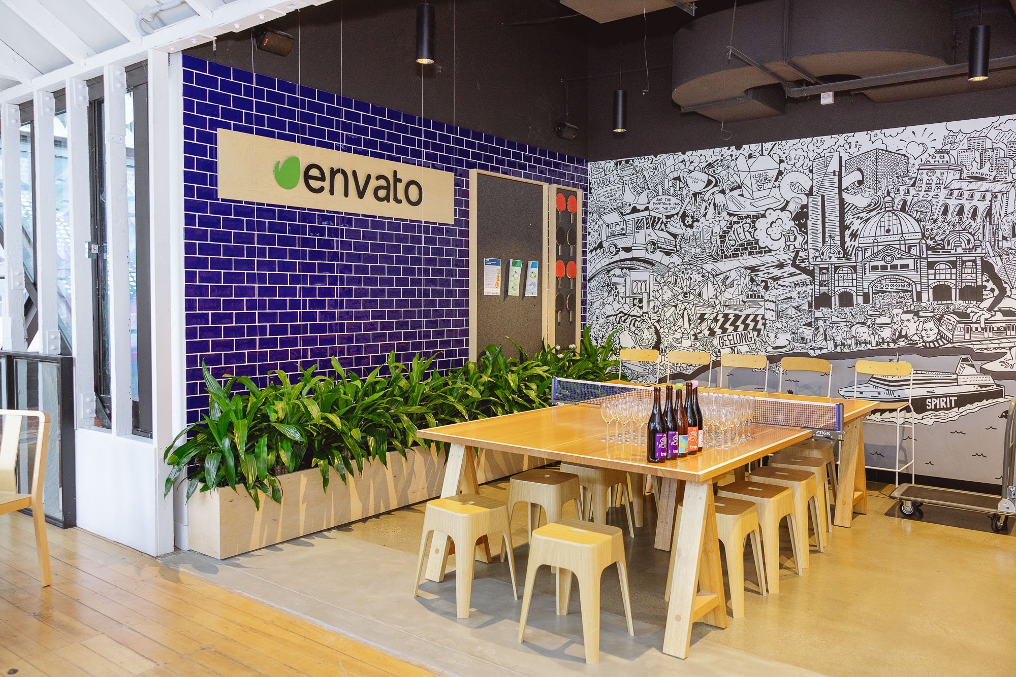 A mural featuring some of Melbourne's most iconic experiences has pride of place in the new Envato kitchen. 