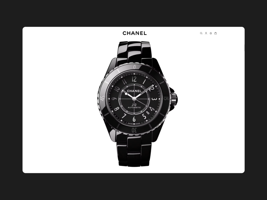 A black Chanel J12 automatic watch with a black dial and white numerals, displayed on a white background within a digital interface.