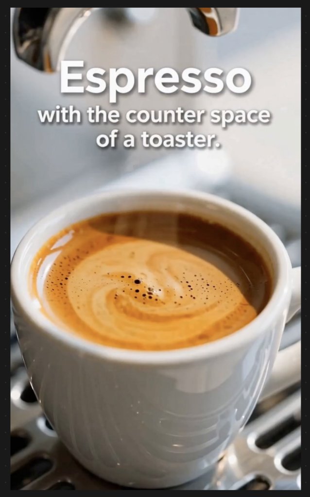 Close-up of a white cup of espresso with rich crema, sitting on a metal grate. White text overlay reads: 'Espresso with the counter space of a toaster.'